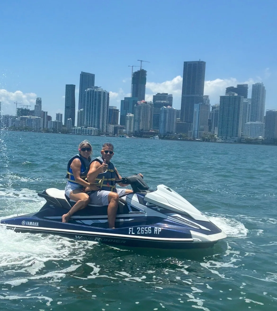 Couple giving thumbs up on a Yamaha WaveRunner in Biscayne Bay