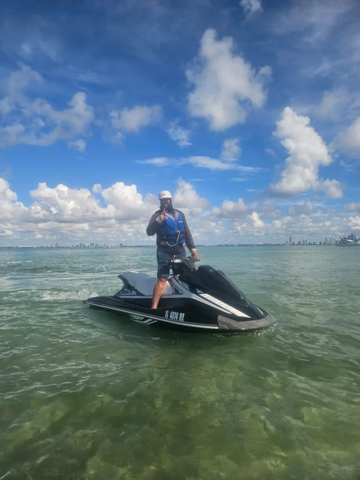 Rider standing on a Yamaha WaveRunner in Biscayne Bay with Miami skyline